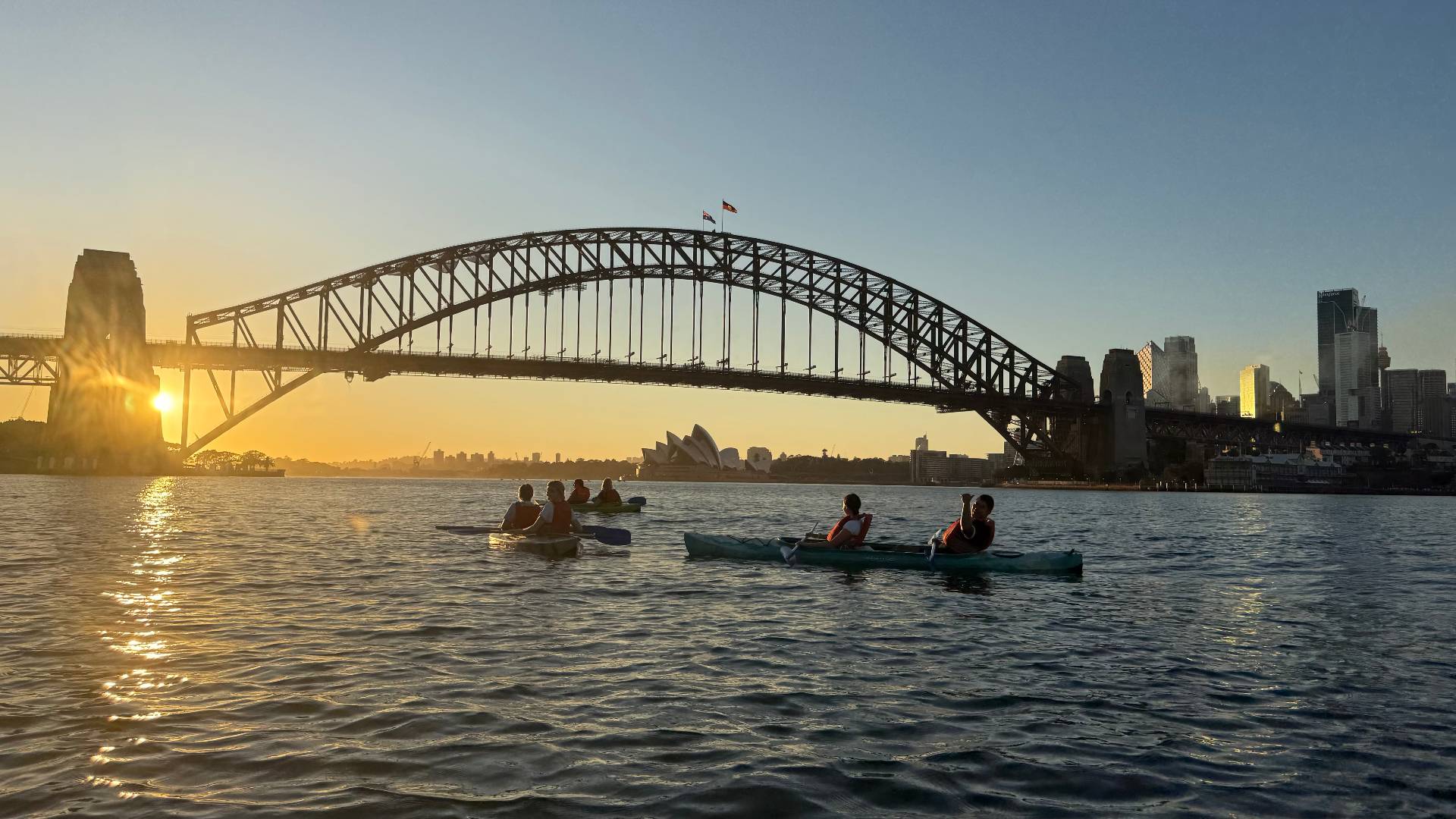 Sydney Kayak Tours sunrise group paddling towards Harbour Bridge