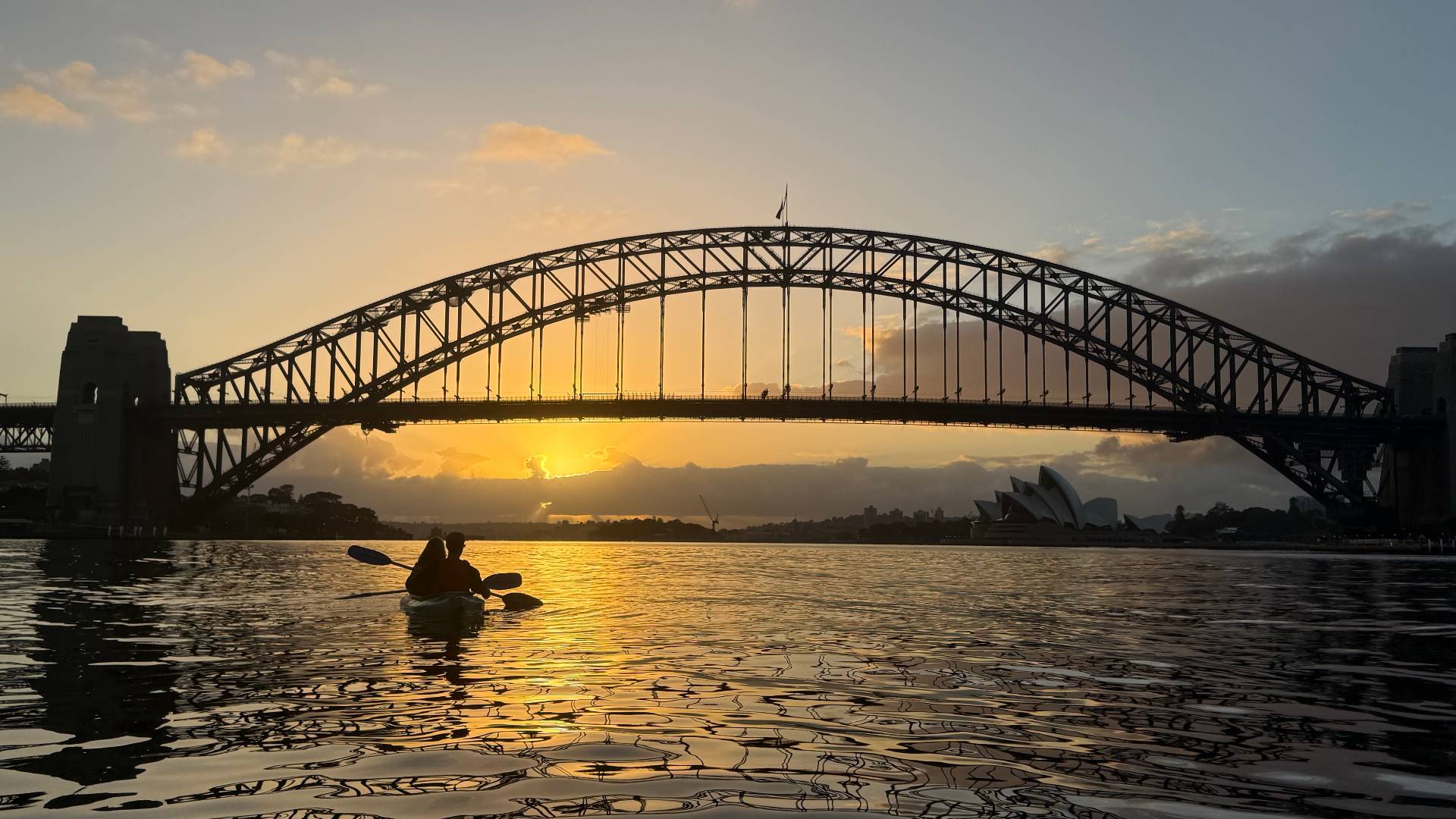 Couple silhouette on sunrise kayak tour Sydney Harbour