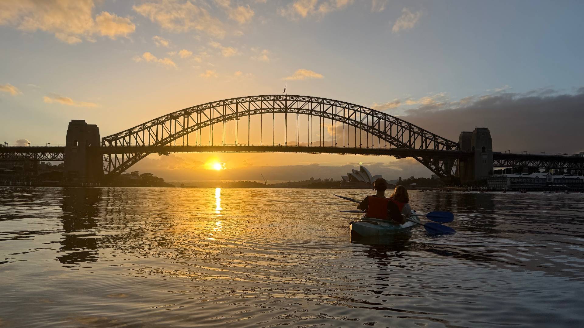 Couple paddling sunrise kayak tour on Sydney Harbour