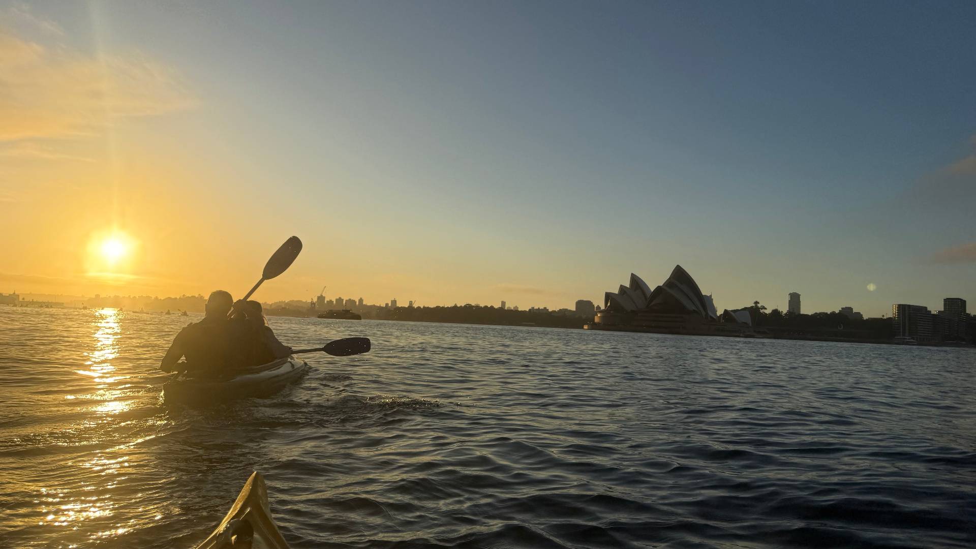 Sunrise kayak tour Sydney – duo paddling towards Sydney Opera House