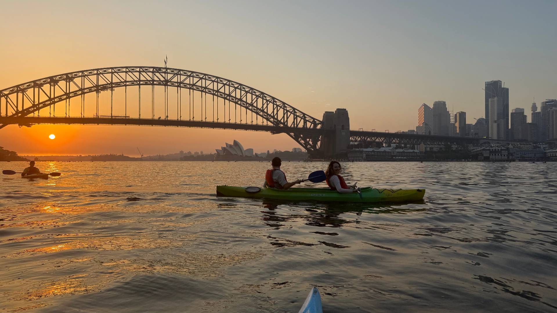 Duo paddling sunset kayak tour on Sydney Harbour