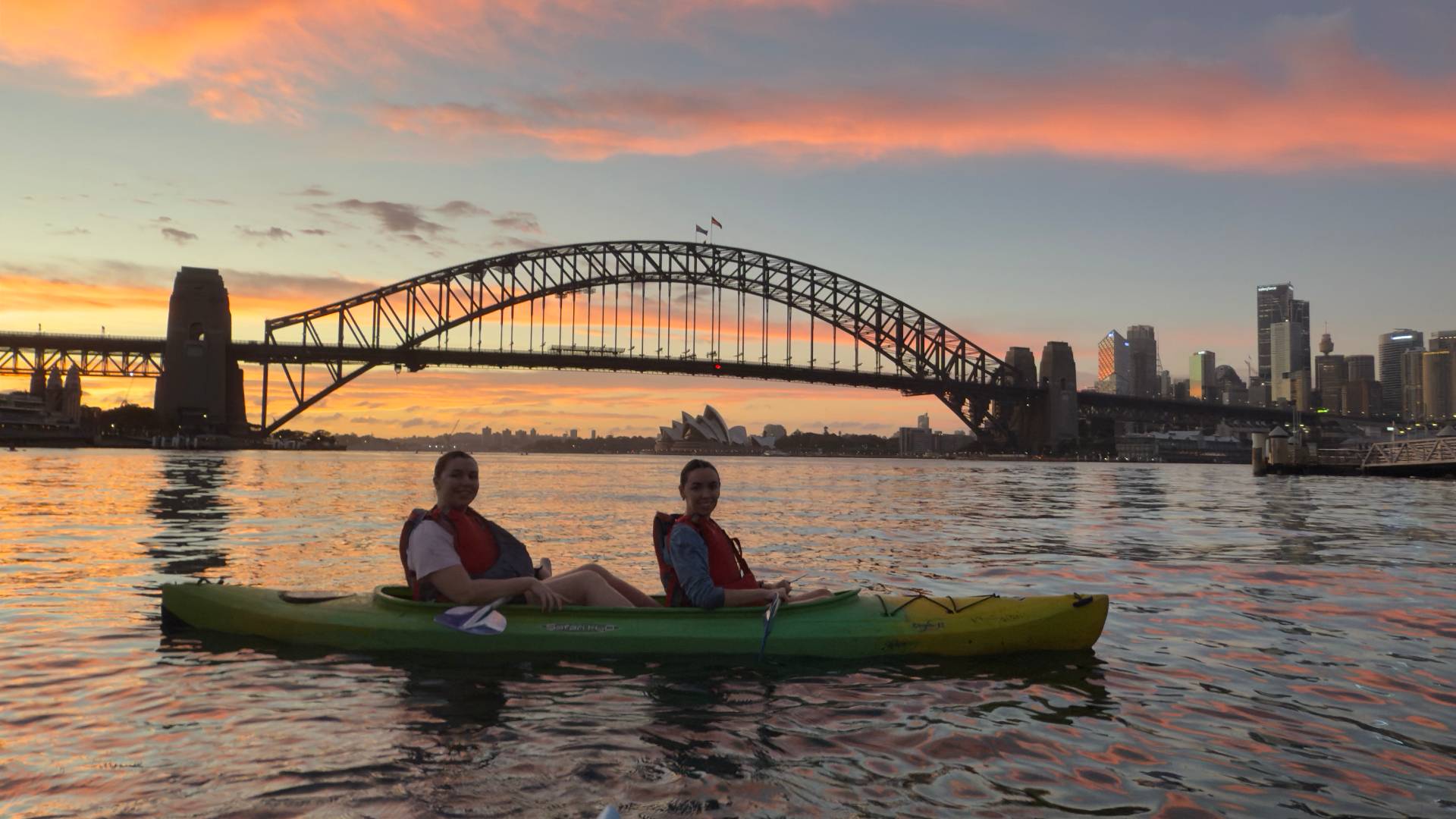 Friends on Sydney Kayak Tours enjoying sunset paddle